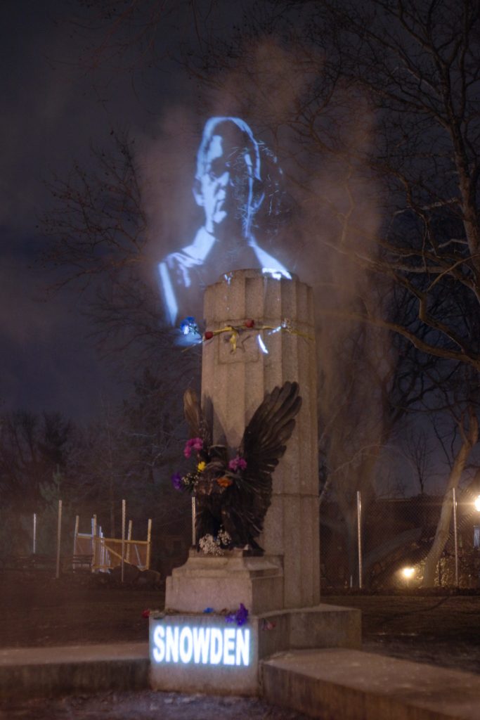 Snowden's face projected and captured in a cloud of smoke